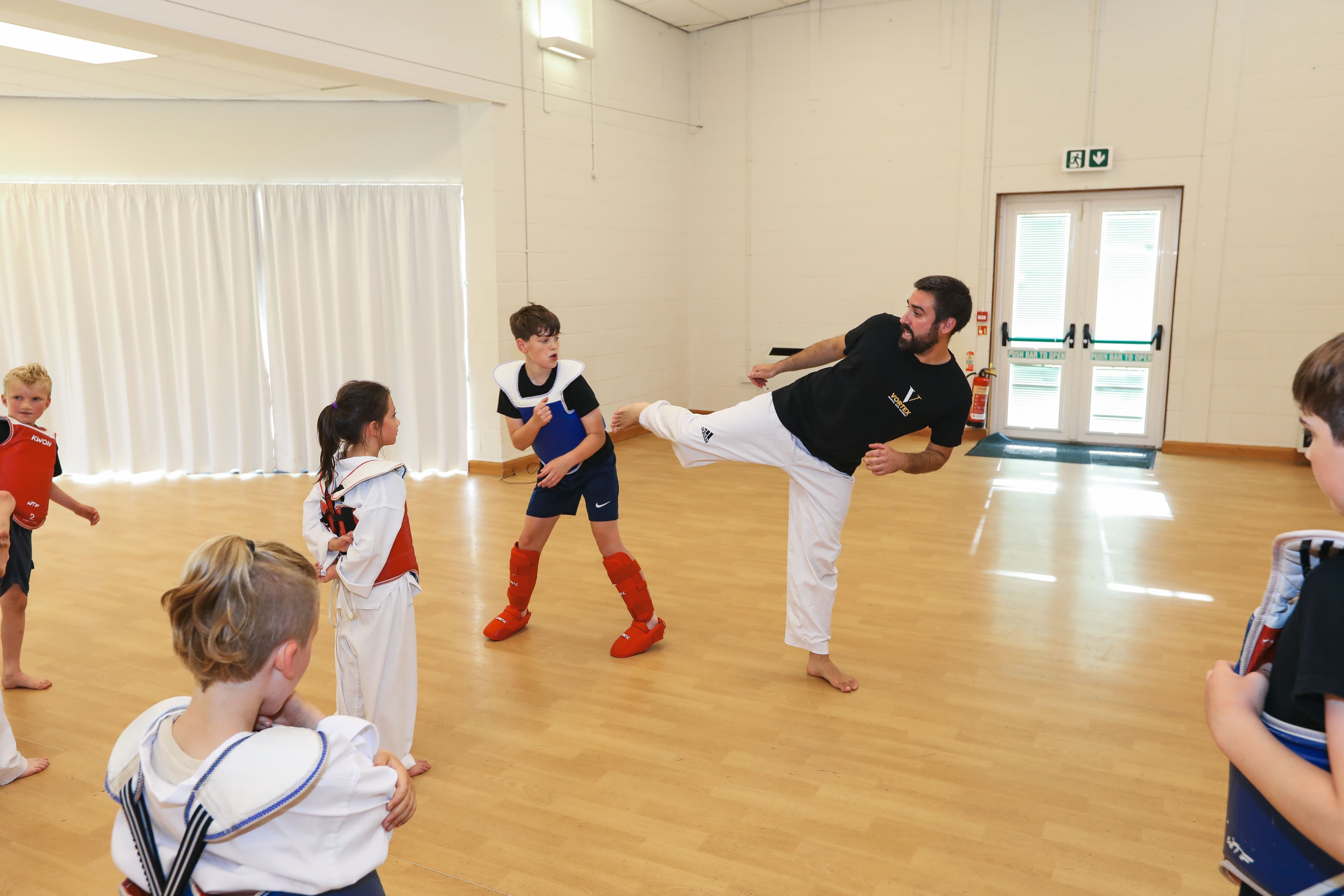 Andy Griffiths demonstrating a side-kick at Vortex Martial Arts Academy Taekwondo class
